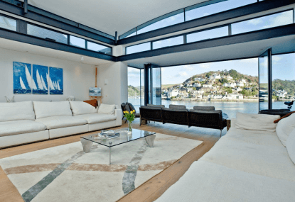 Stylish open cottage interior with sea views.
